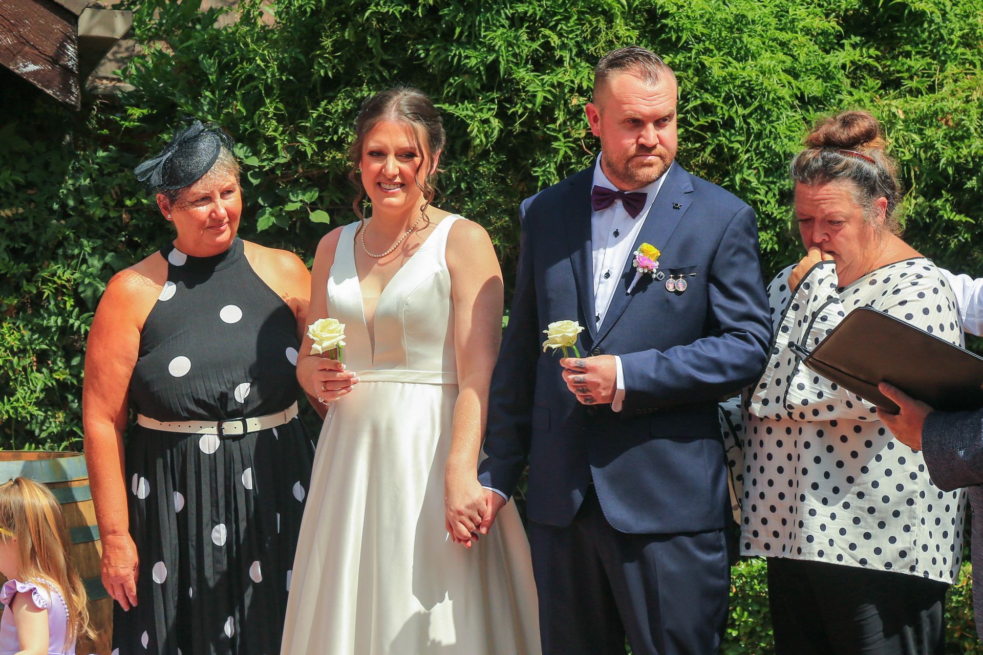 Four People Standing Outdoors at A Wedding, Including a Bride in A White Dress and A Groom in A Navy Suit — Craig Stevens Photography in Pearl Beach, NSW