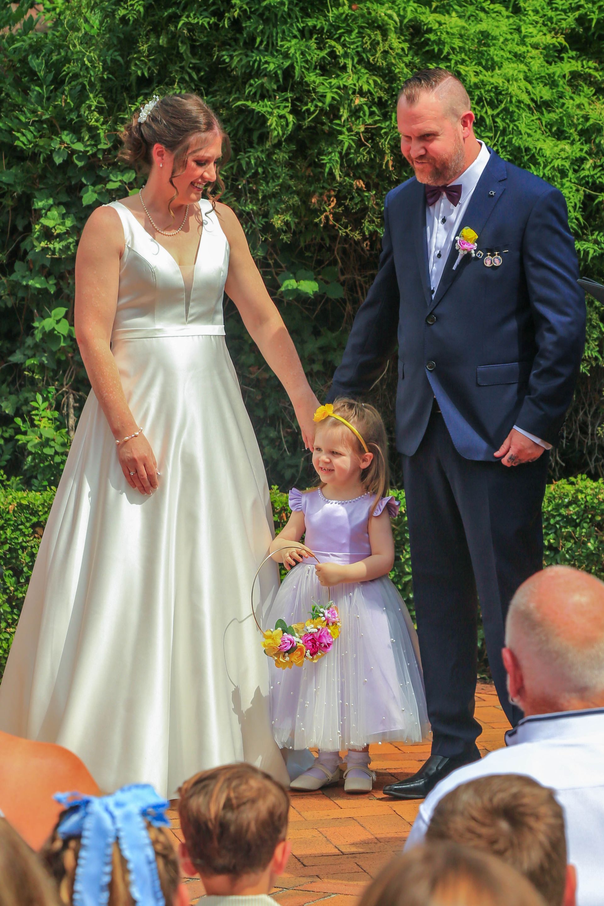 Bride, Groom, And Young Flower Girl Stand Together — Craig Stevens Photography in Pearl Beach, NSW