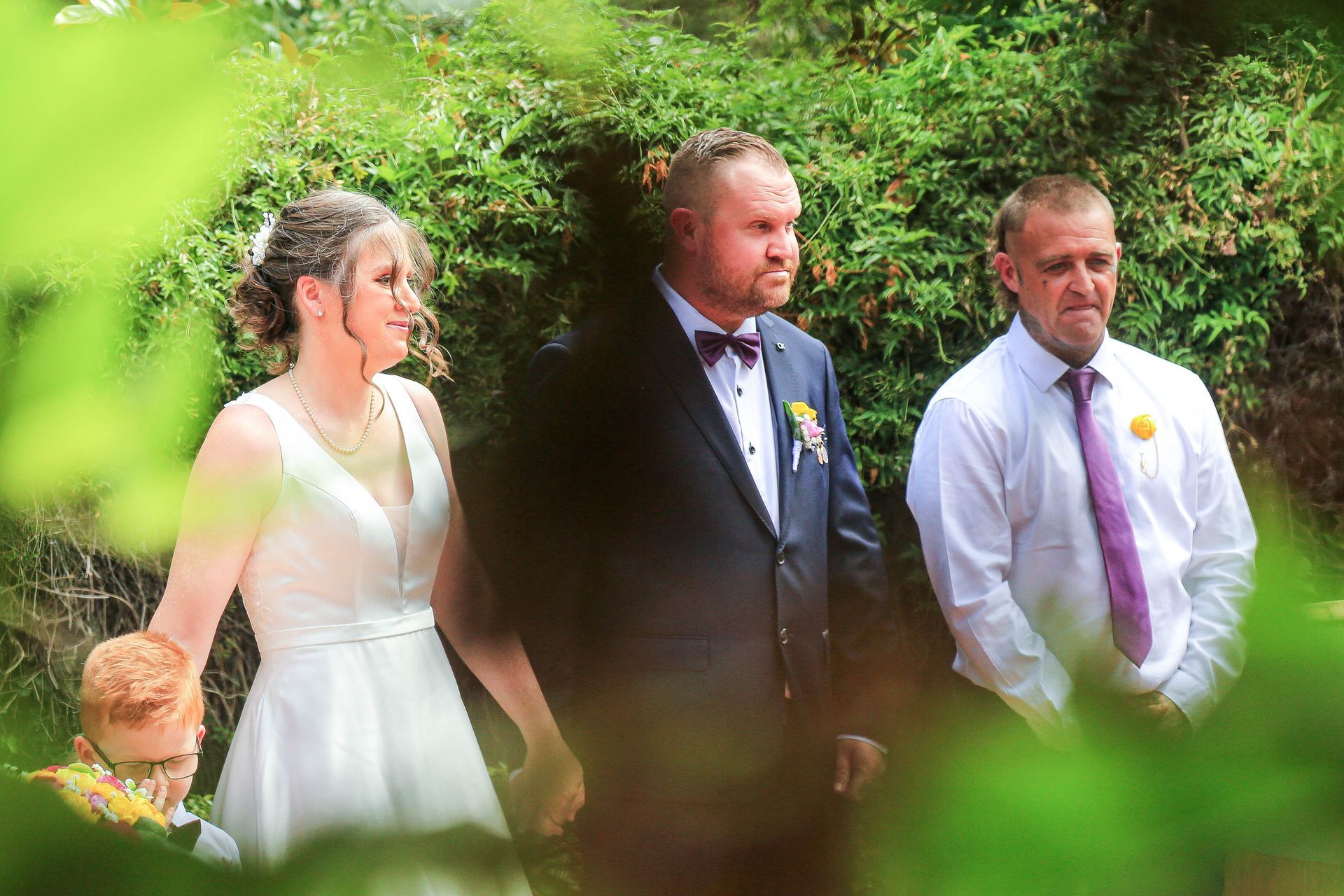 Bride And Groom Walking Outdoors With A MAN In A Tie — Craig Stevens Photography in Pearl Beach, NSW