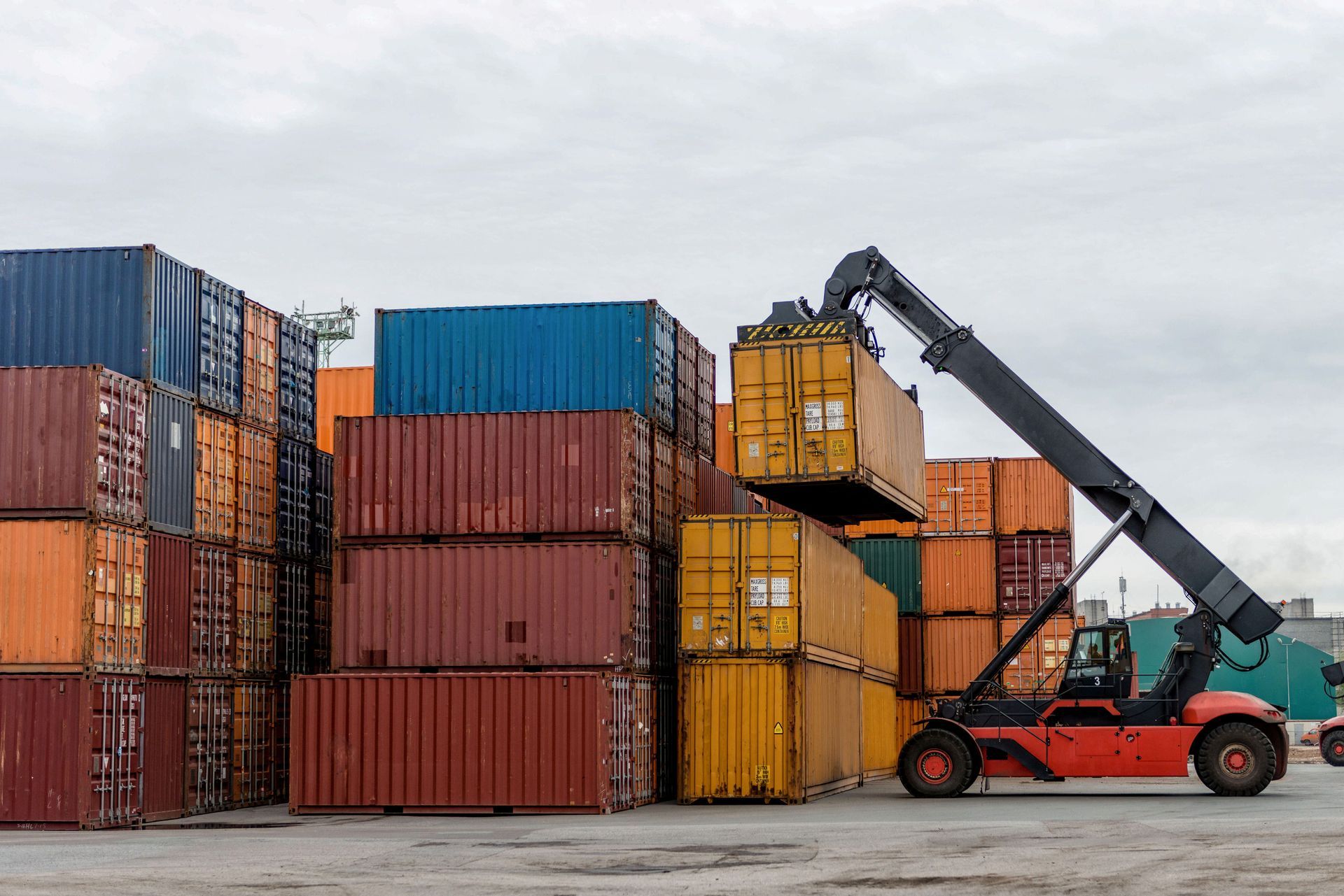 Mobile stacker handler in action at a container terminal. Mobile stacker handler in action at a container terminal.