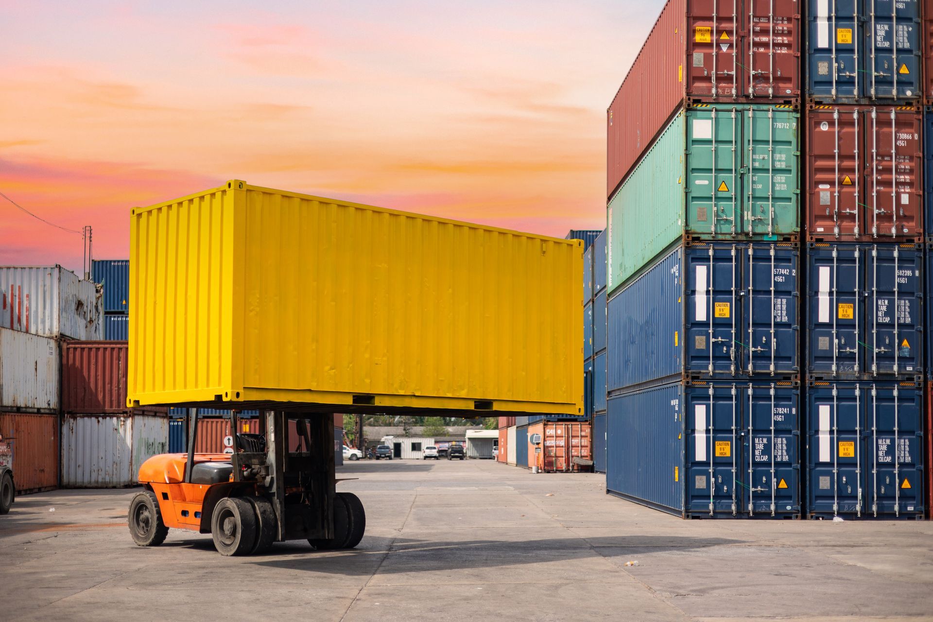 some containers with a crane lifting up