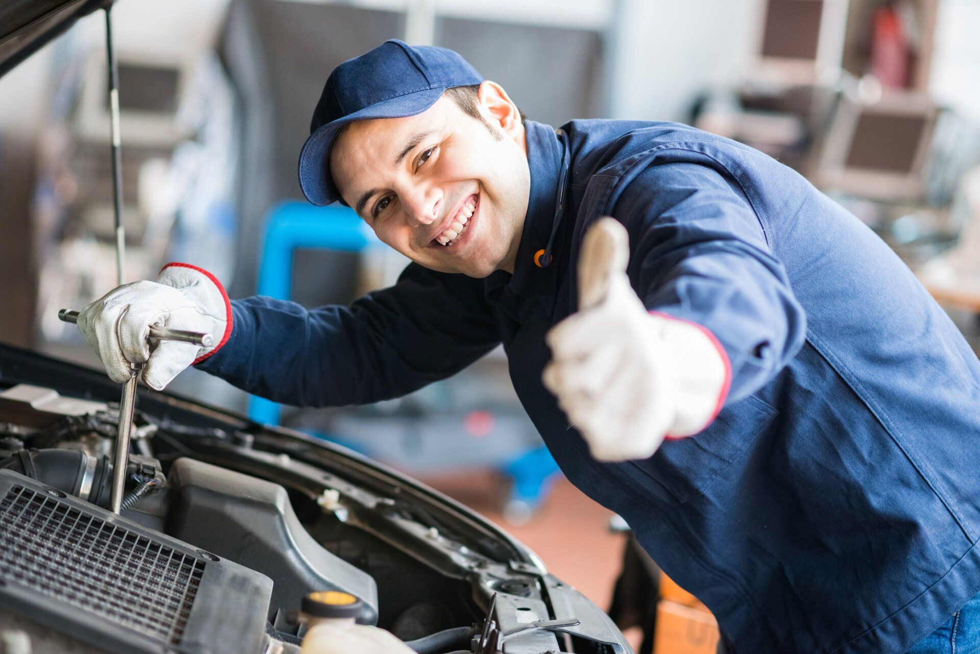 Car mechanic gesturing thumbs up