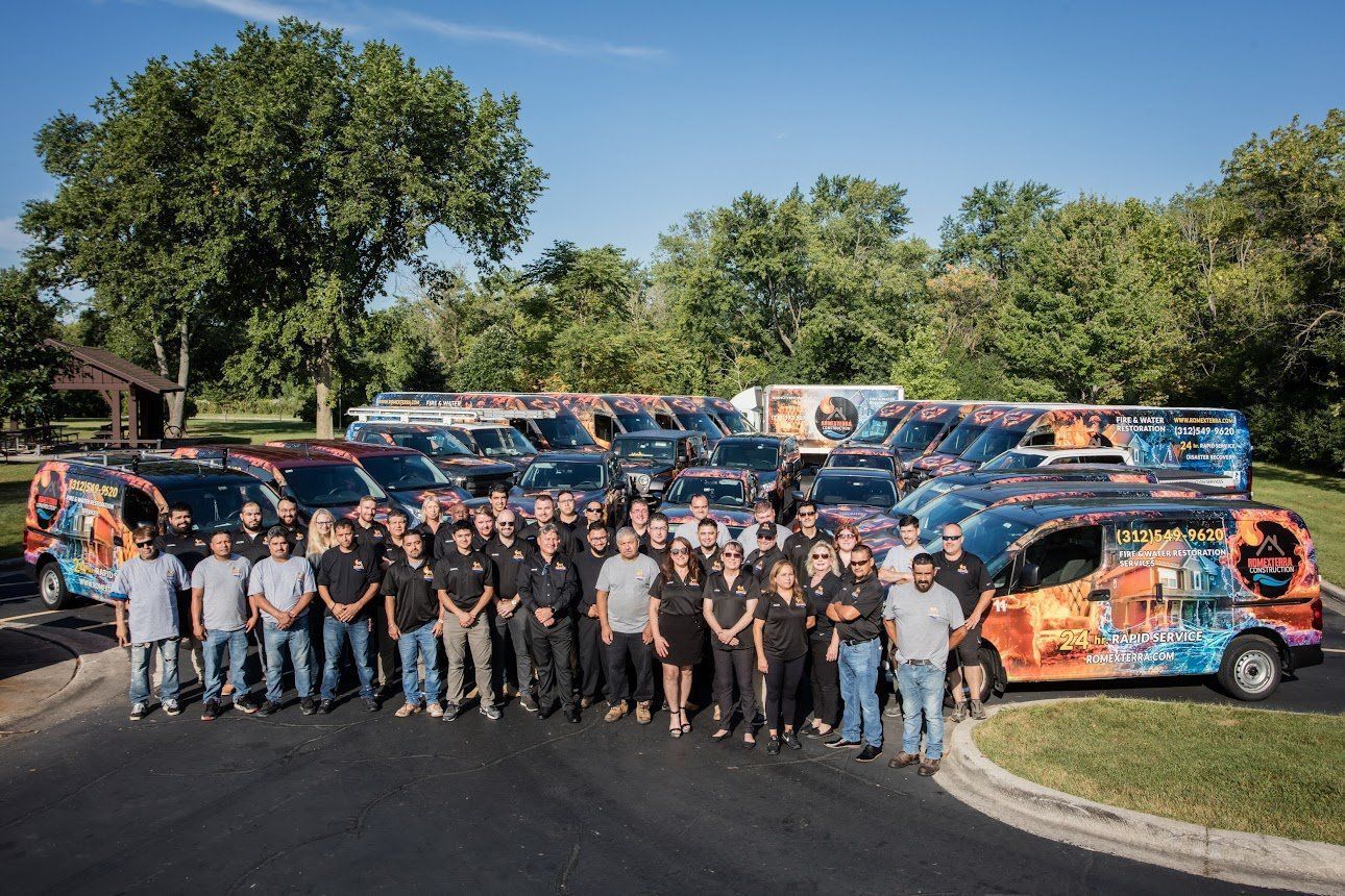 A group of people standing in front of a row of vans.