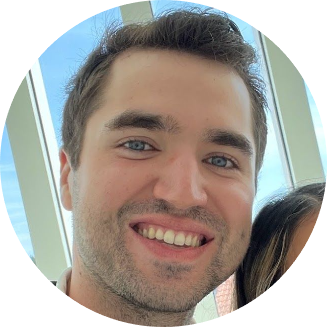 A man with a beard and blue eyes is smiling in a circle