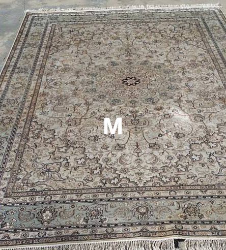 A rug is sitting on top of a concrete floor.