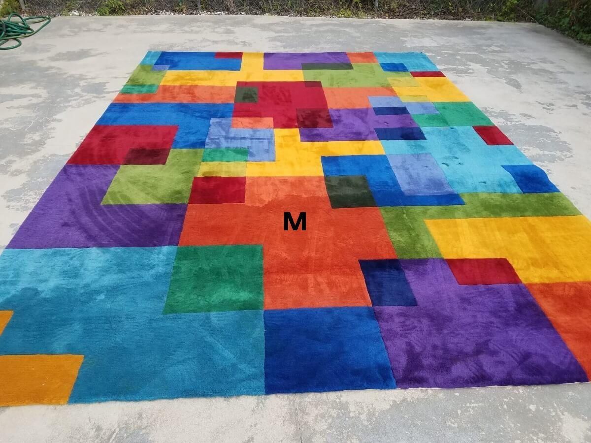 A colorful rug with the letter m on it
