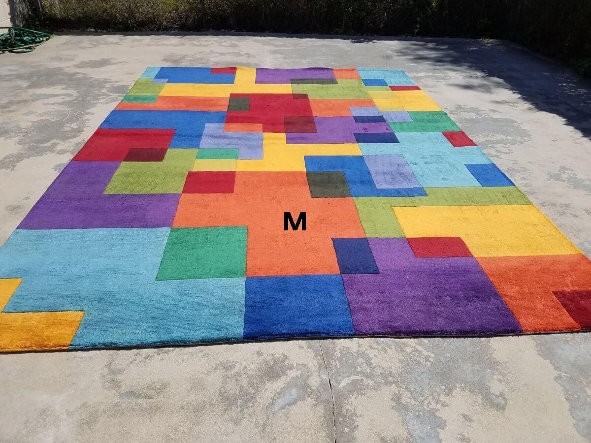 A colorful rug with the letter m on it
