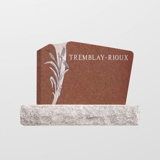 Pierre tombale en granit rouge avec motif de blé gravé, TREMBLAY-RIOUX, posée sur un socle en pierre.