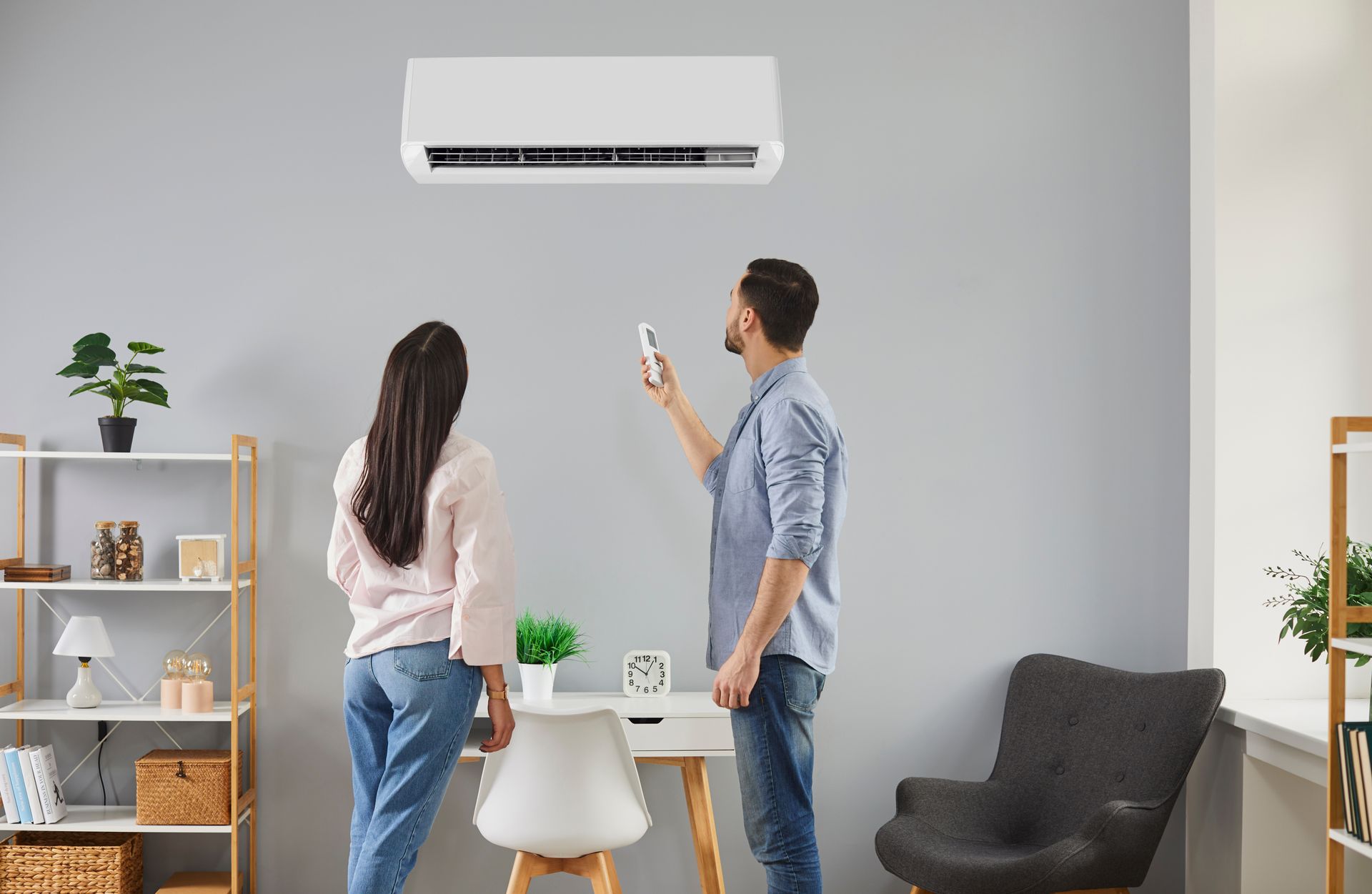 A young couple examines their home HVAC system.