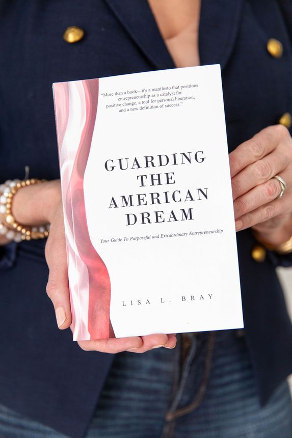 a woman is holding a book titled guarding the american dream