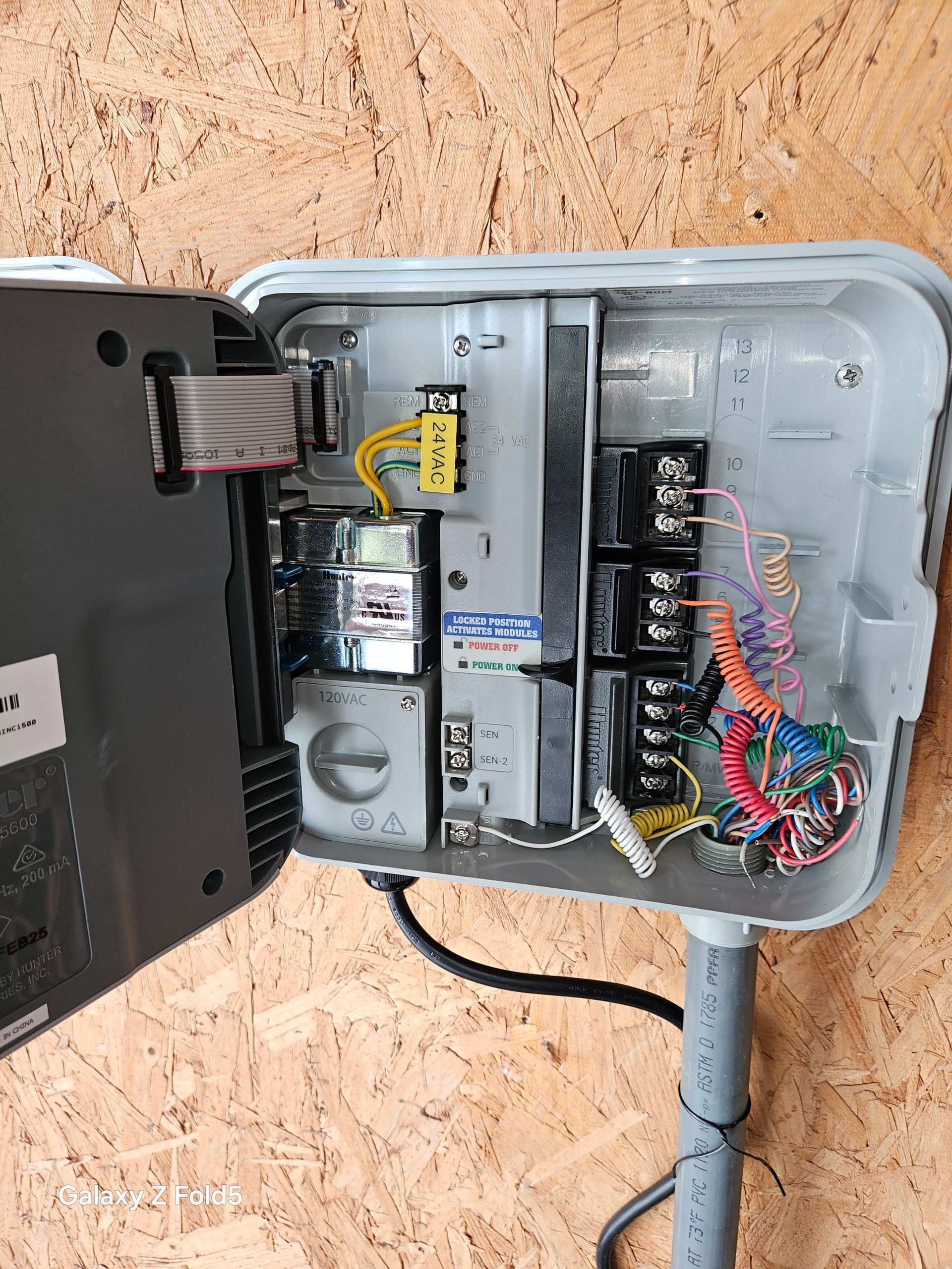 A gray box with a bunch of wires coming out of it.