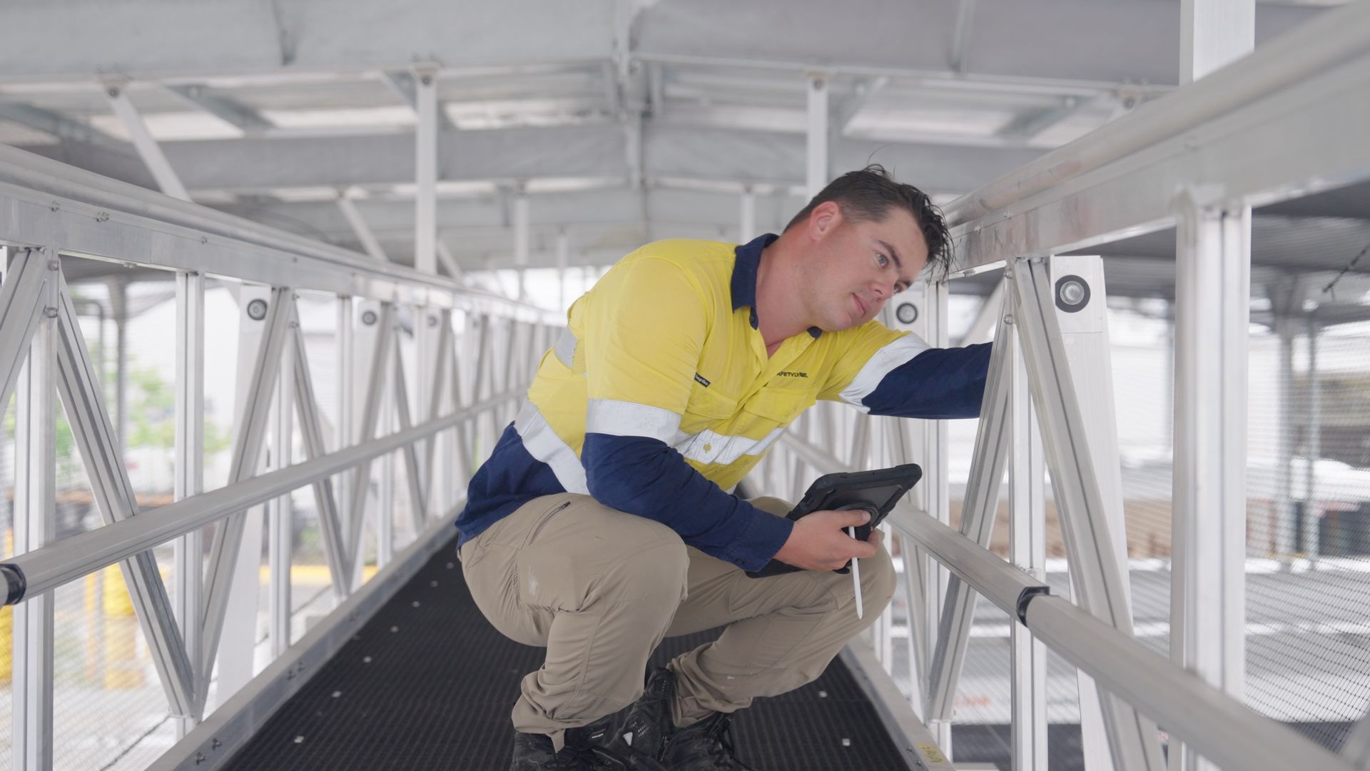 Suspended walkway bridge deck for overhead maintenance
