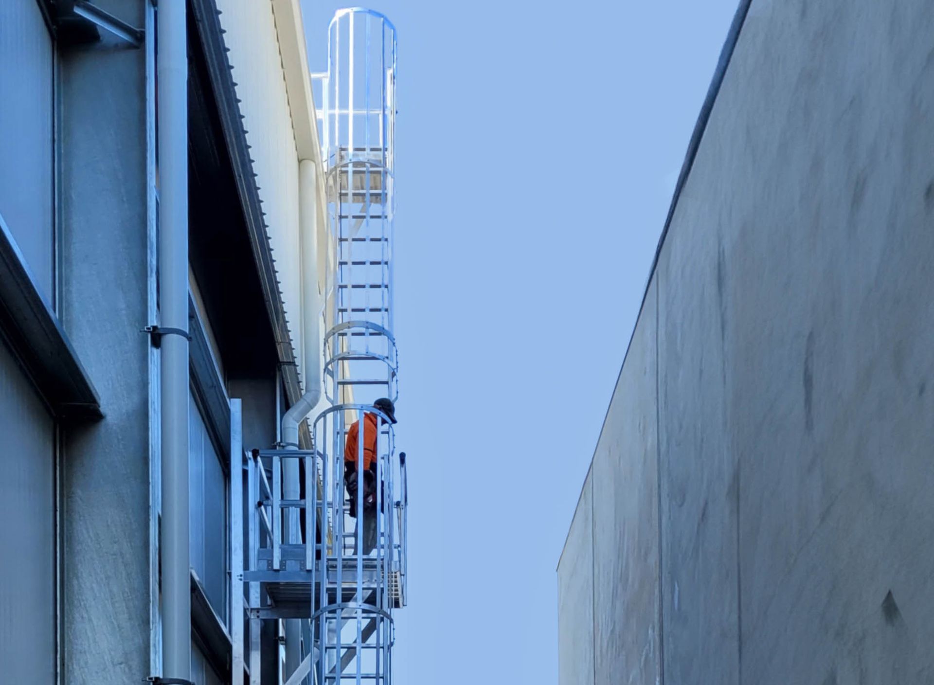 Stair access system to a rooftop of a tall cold storage facility 