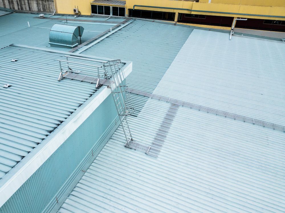 Caged ladder with a landing platform and roof walkways - aerial photo. Complete roof safety system
