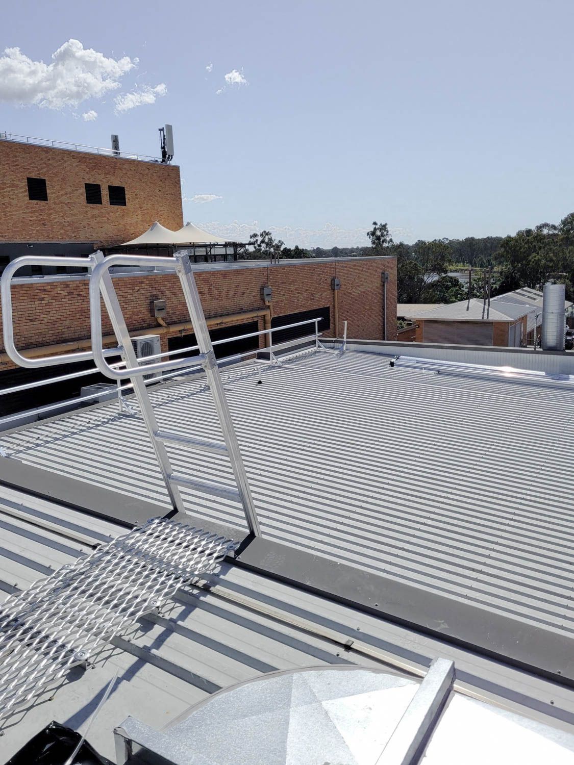 rooftop access ladder with a walkway