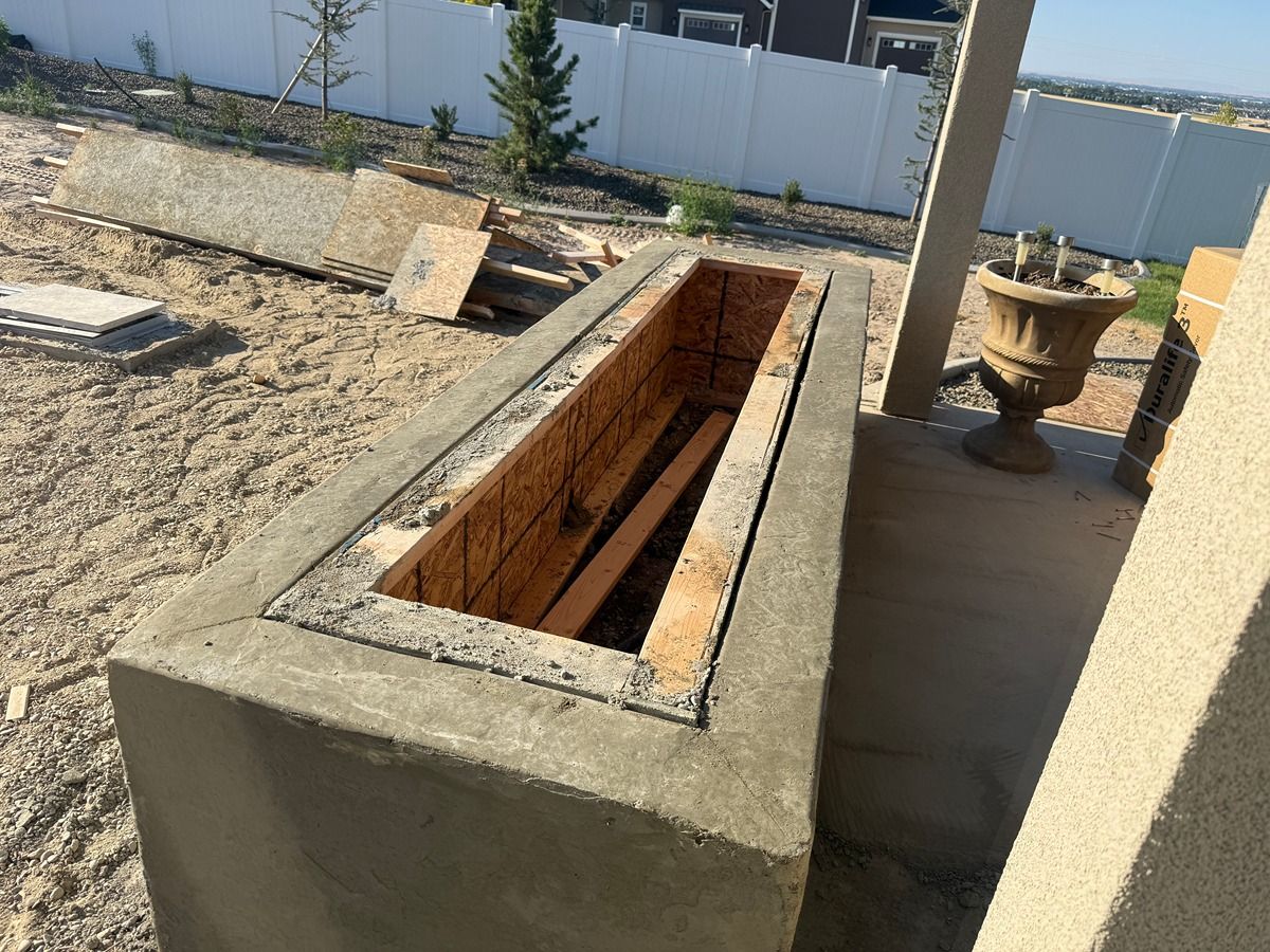 Long rectangular concrete trough or planter in a sunlit outdoor yard