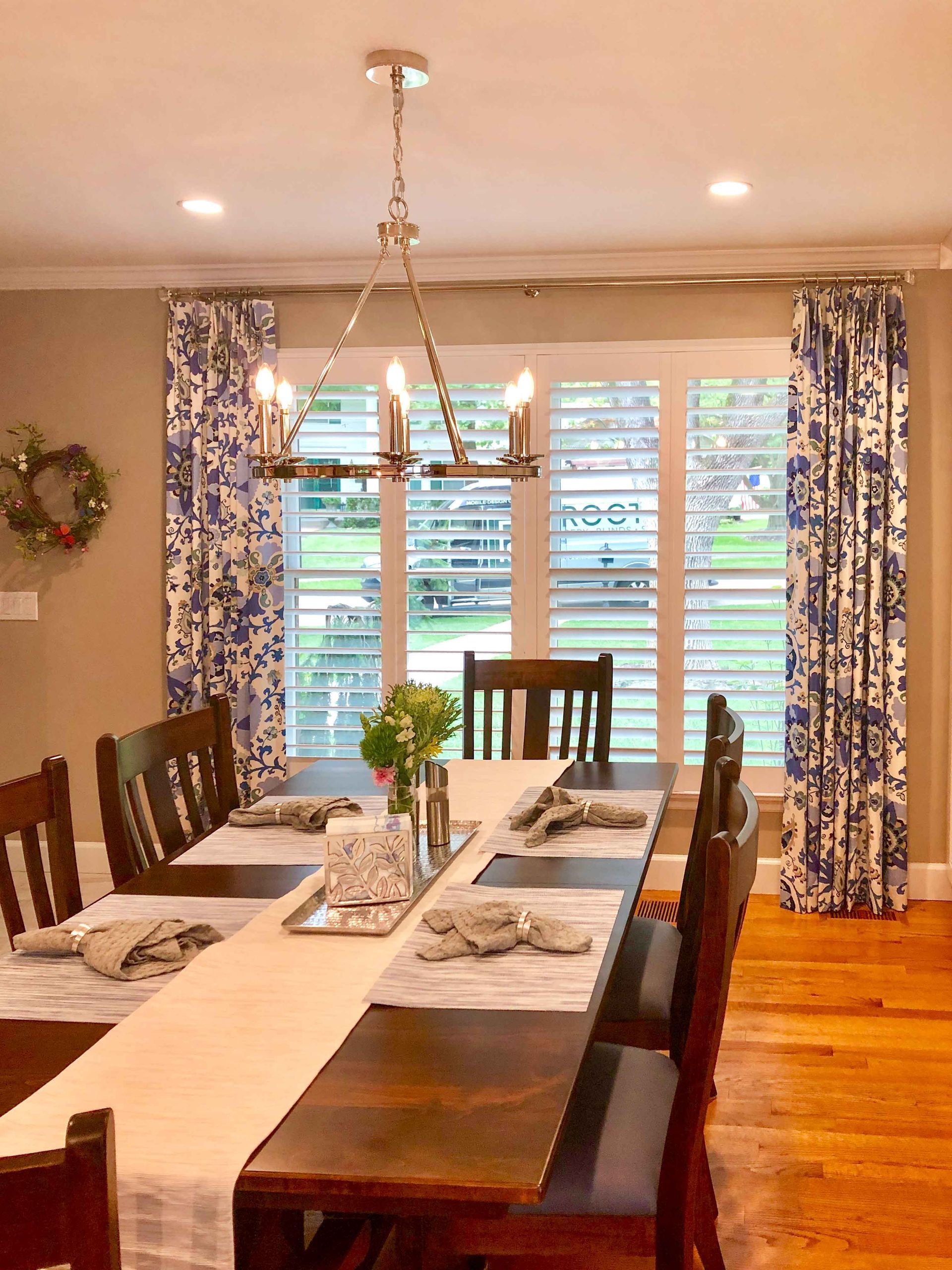 A dining room with a long table and chairs and a chandelier