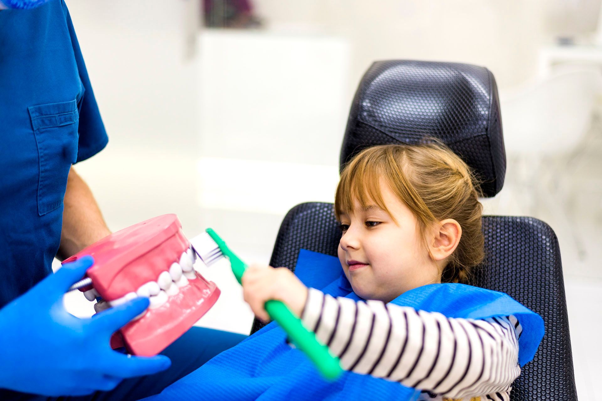 Dentist Teaching a Girl Oral Hygiene — Mandeville, LA — Northshore Pediatric Dentistry Dentist Teaching a Girl Oral Hygiene — Mandeville, LA — Northshore Pediatric Dentistry