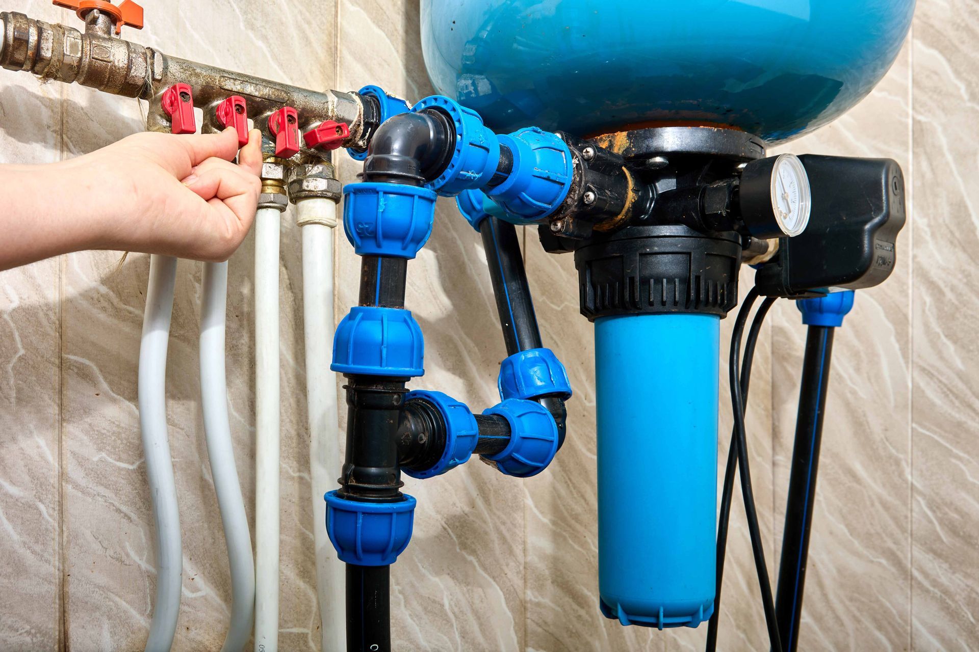 Close-up of plumbing manifold during a routine water well pump service call.