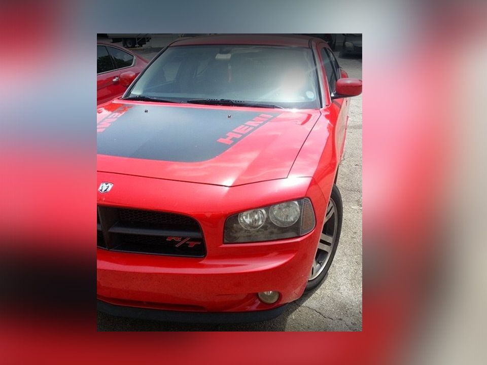 Red sports car with black hood parked outdoors, front view | Mechanic On Duty CB LLC