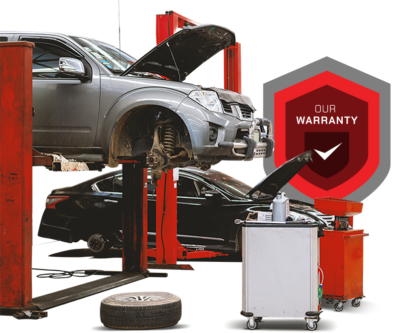 Car on a lift in an auto shop with tools, tires, and a red warranty shield logo | Mechanic On Duty CB LLC