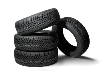 Stacked black car tires on a white background, with one tire leaning against the stack. | Mechanic On Duty CB LLC