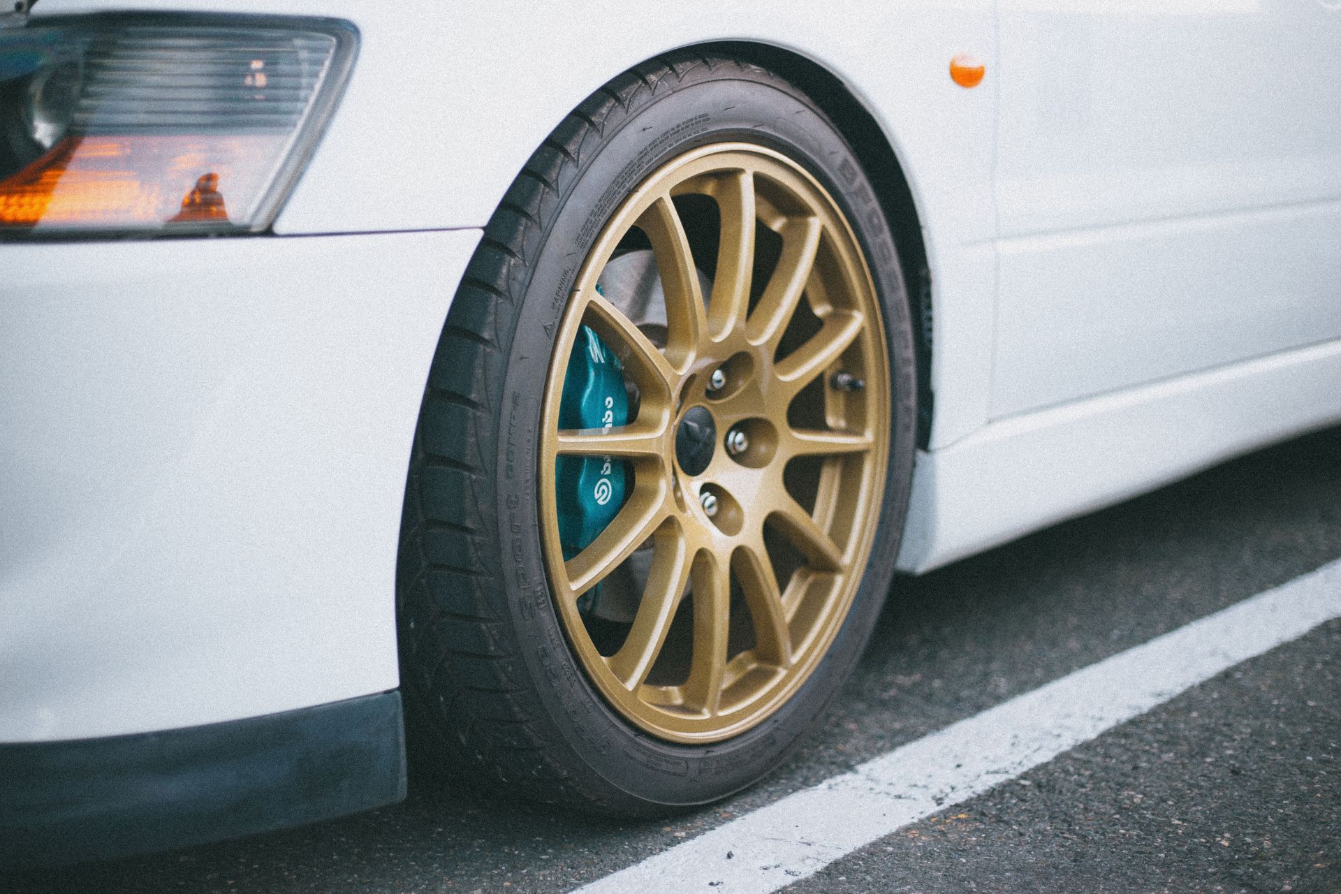 tire on white vehicle | Rozema's Car Care