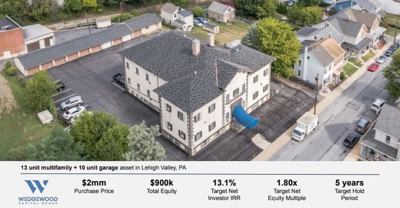 An aerial view of a building with a blue arrow pointing to it.