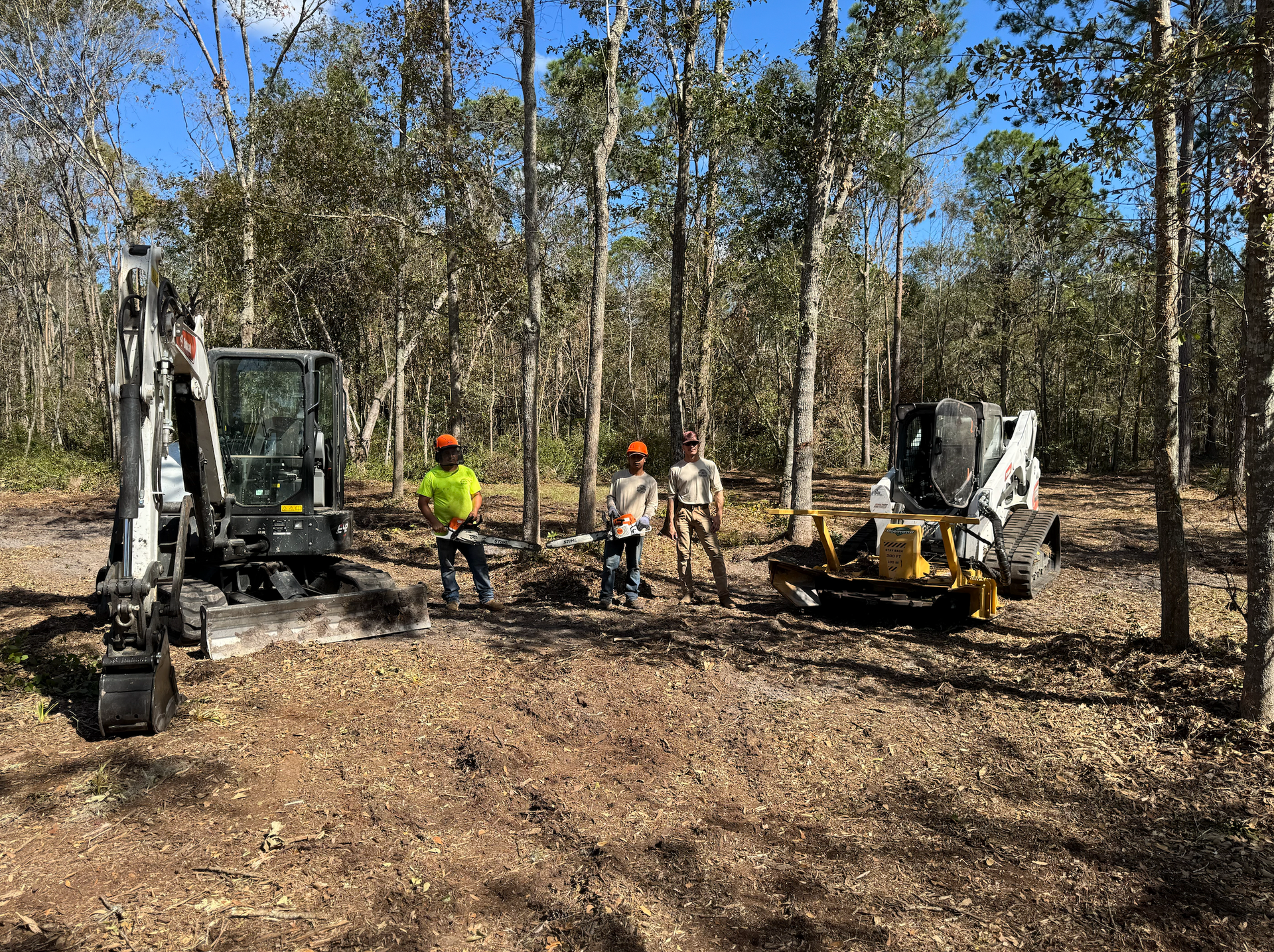 Picture of crew in front of forestry equipment