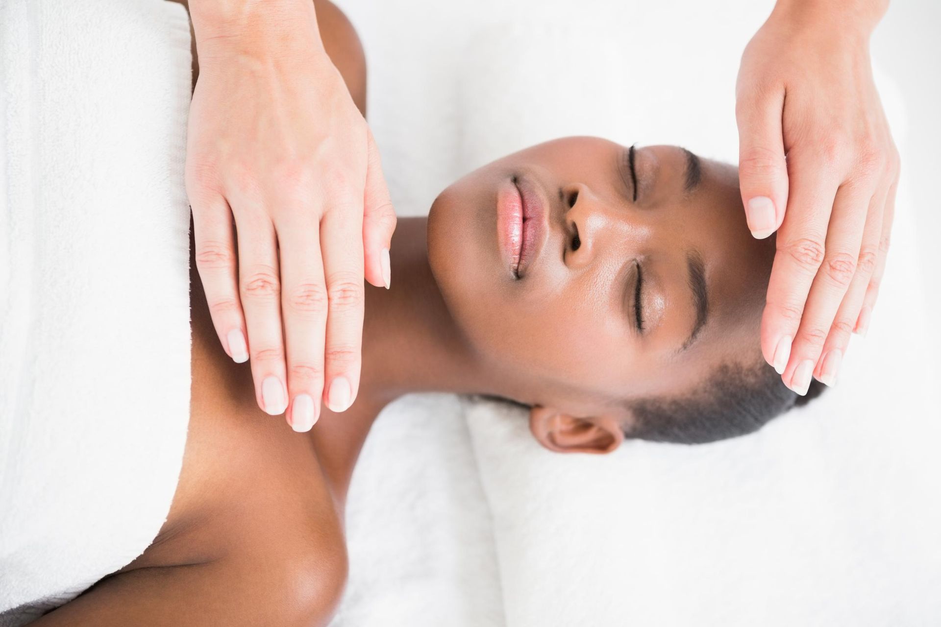 A Woman Is Laying On A Bed Getting A Massage With Her Eyes Closed — Hands on Healing Massage In Tamworth, NSW