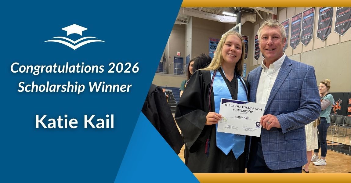 Katie Kail receives a 2026 scholarship award certificate on a stage with a man beside her.