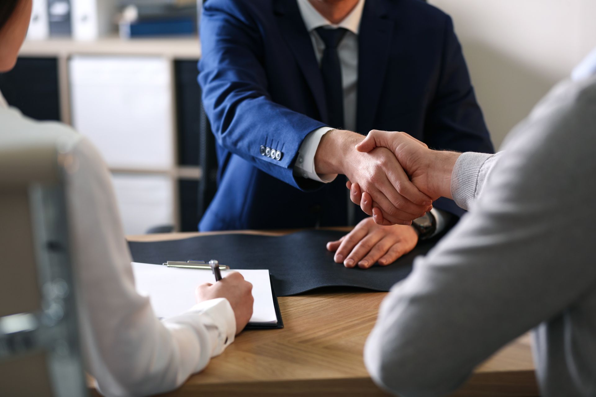 Male attorney consulting clients, highlighting legal attorney services.