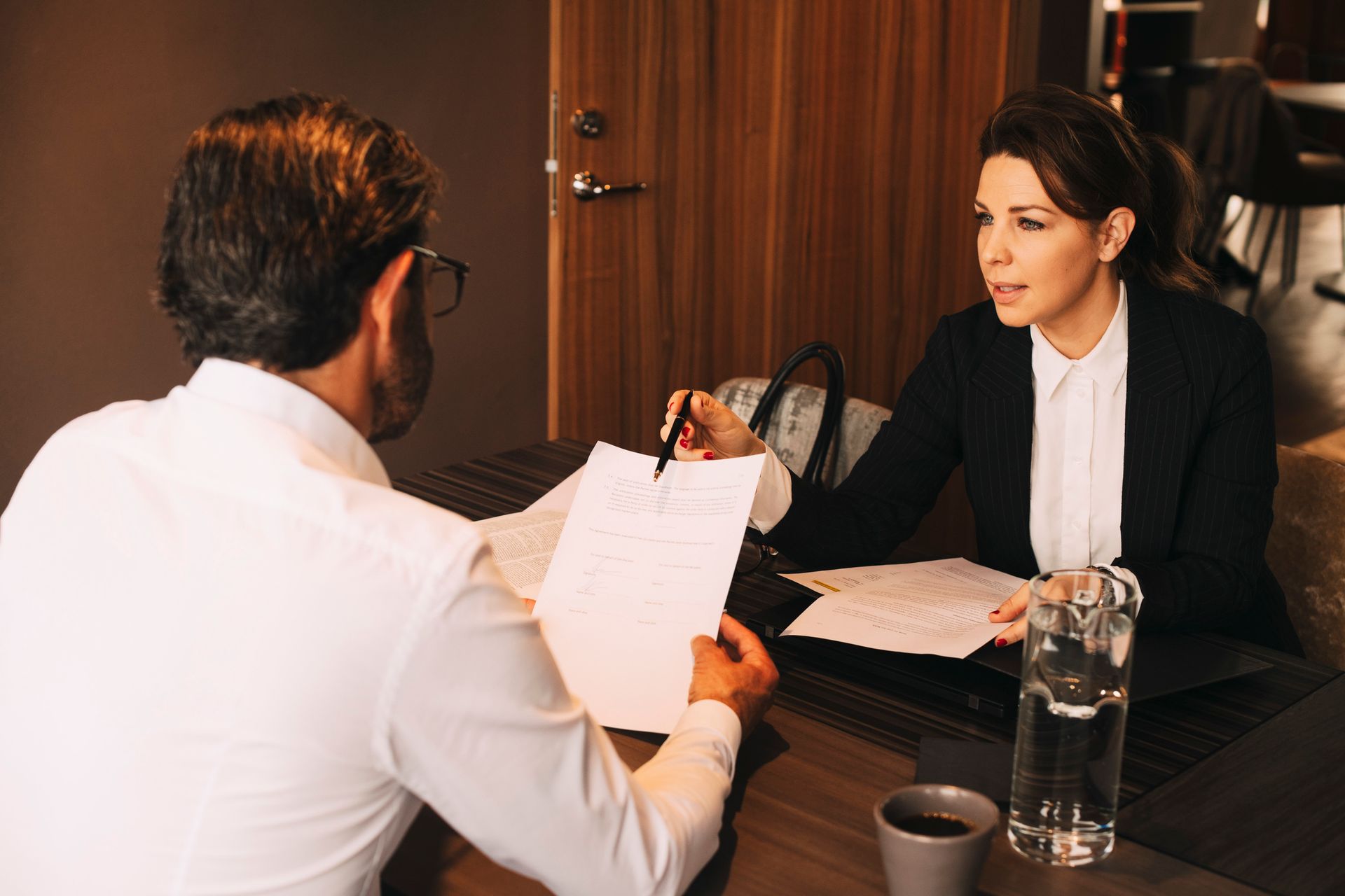 An attorney is explaining a document to her client.