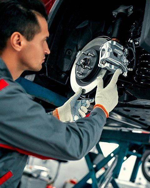 Mechanic Inspecting Car Brake | Aiken, SC | Morris Tire & Auto Mechanic Inspecting Car Brake | Aiken, SC | Morris Tire & Auto