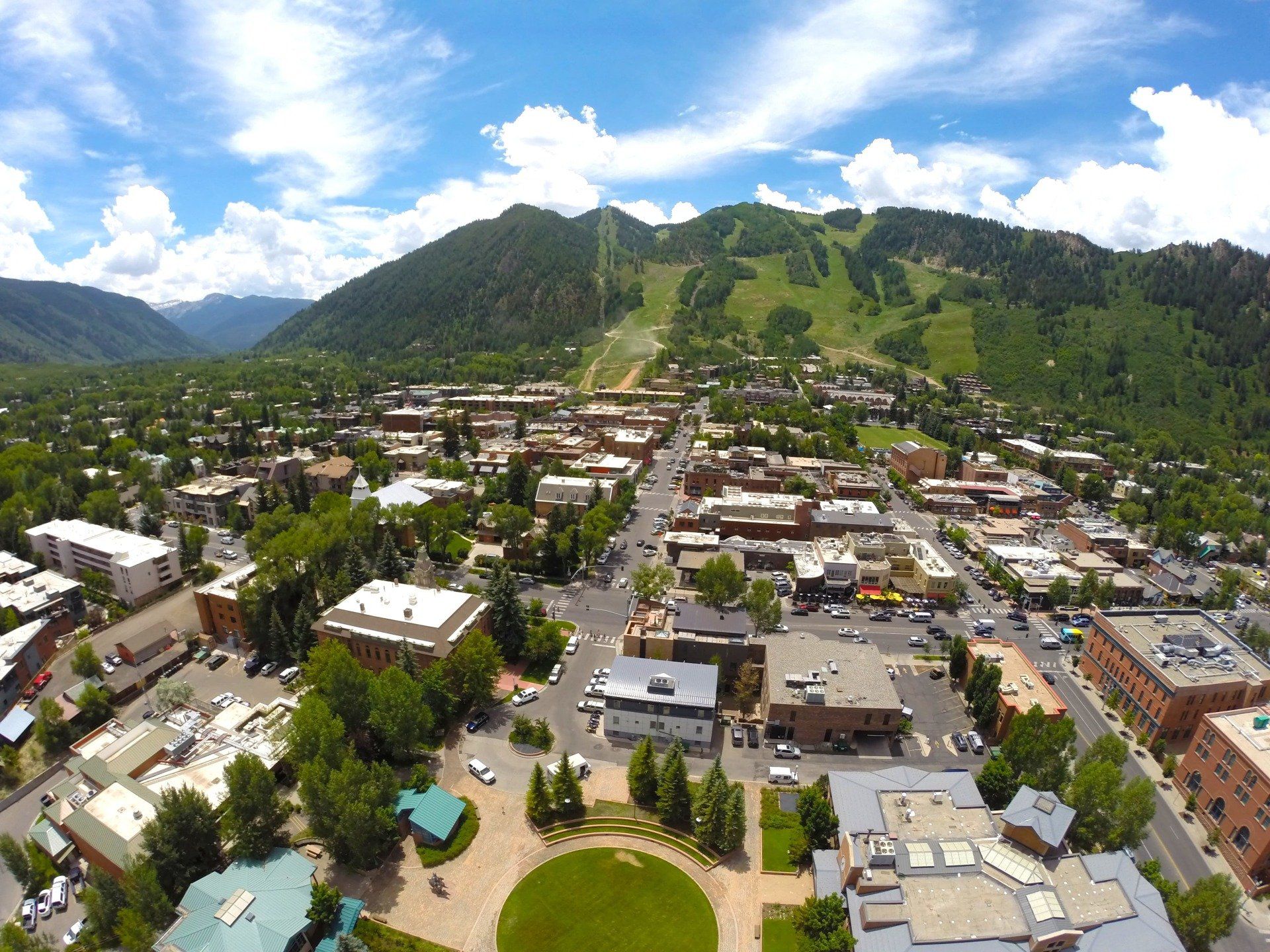 Aerial view of Aspen, Colorado with mountain with ski slopes in the background.