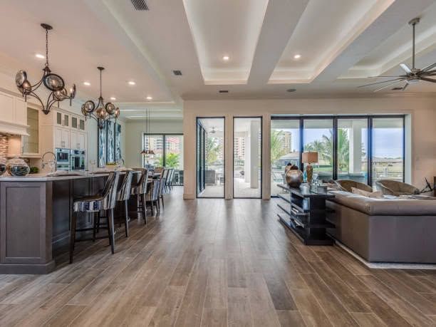 Spacious modern living room with bar, sectional sofa, and large glass doors to a bright patio.