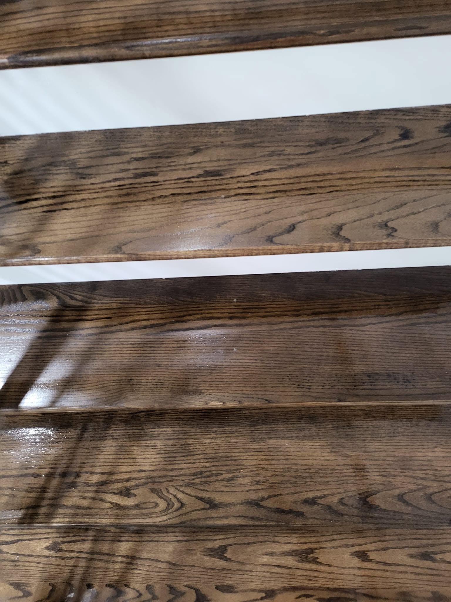Two horizontal strips of dark wood grain with a white gap between them