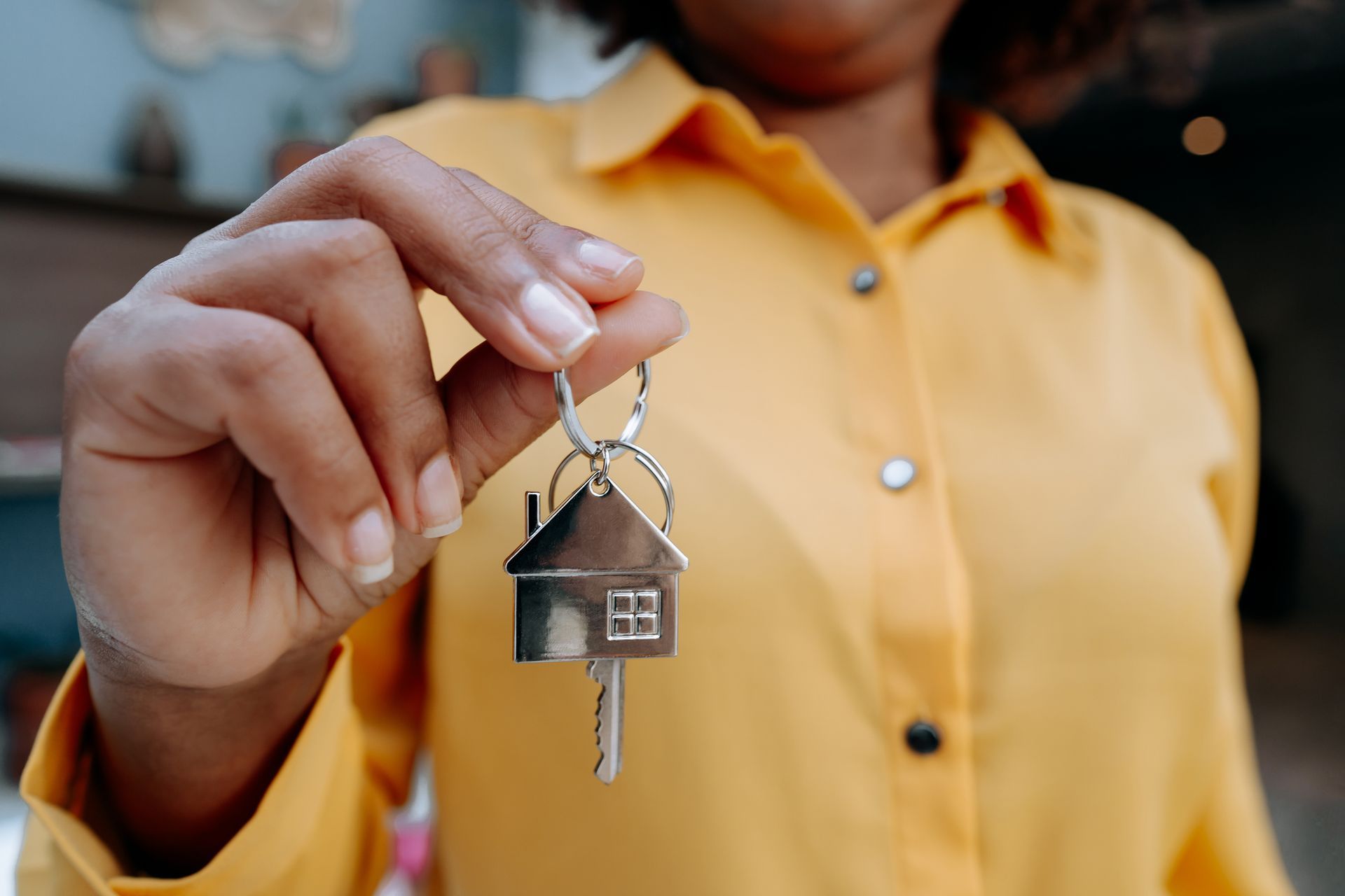 Woman Holding House Key — Insurance in San Antonio, TX Woman Holding House Key — Insurance in San Antonio, TX