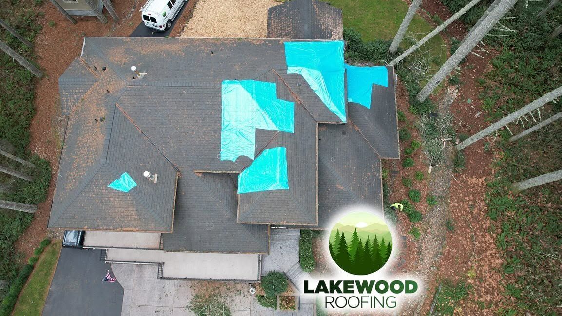 Aerial view of a roof undergoing construction and Lakewood logo at the bottom right