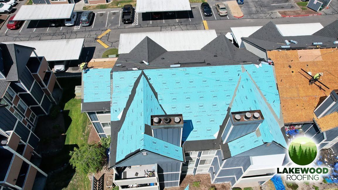 Aerial view of a roof undergoing repair in a residential neighborhood