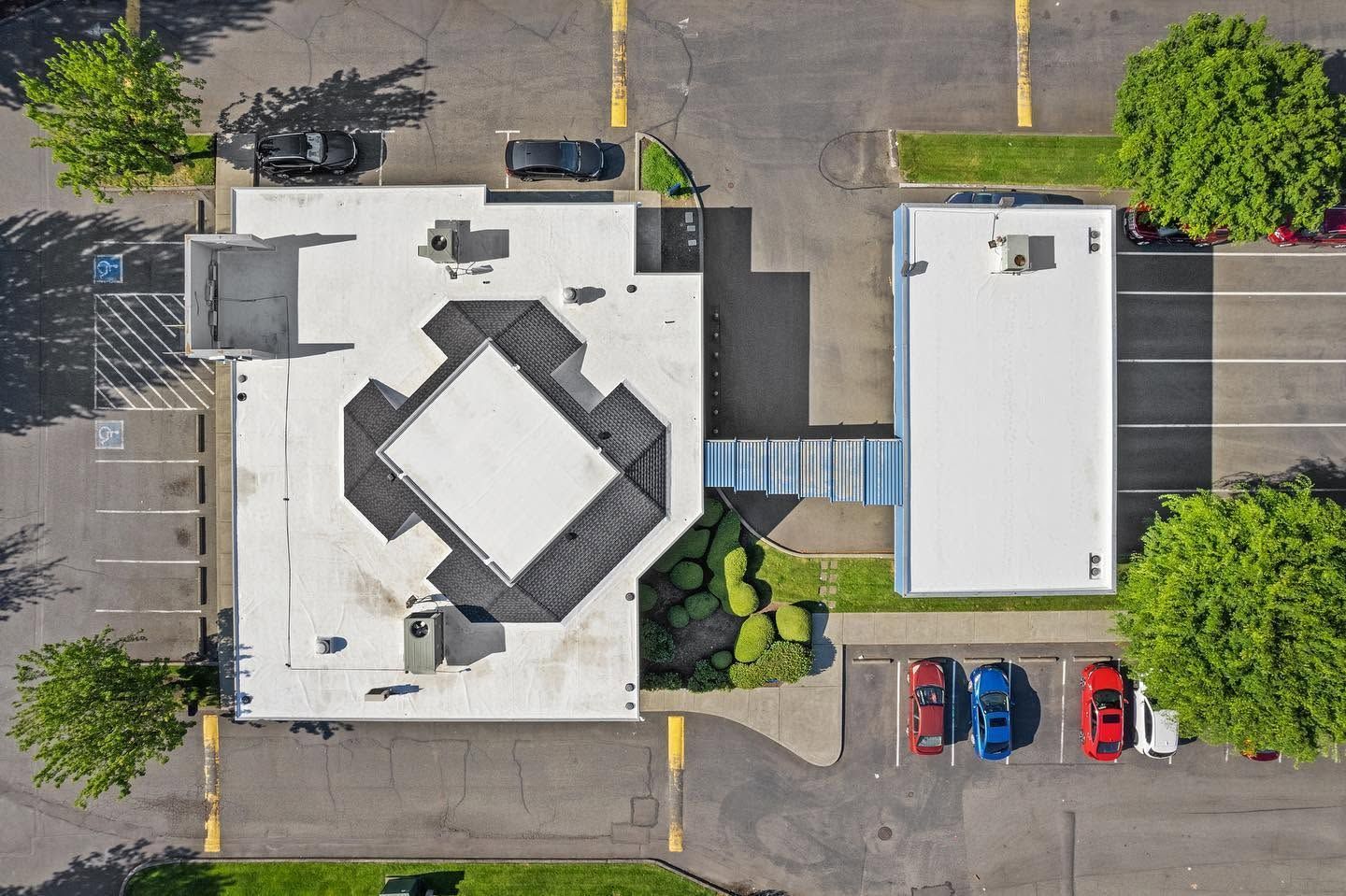 Aerial view of two buildings and parking lots