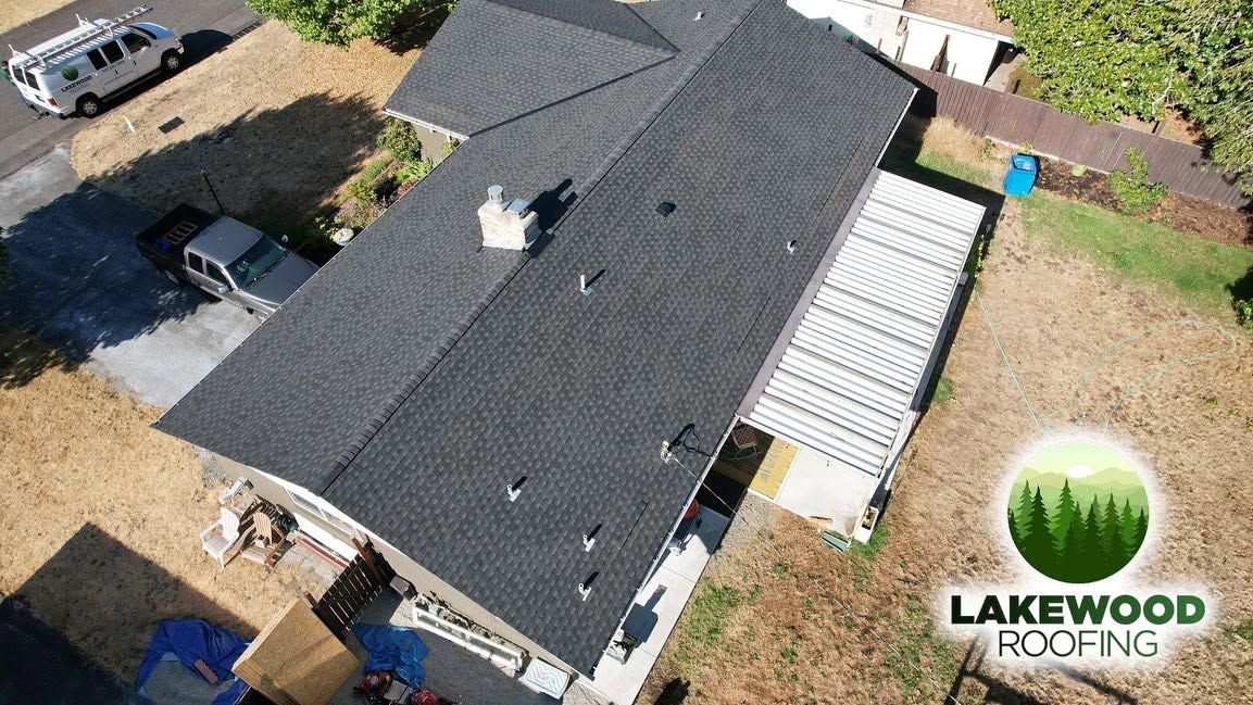 Aerial view of a dark gray roof and Lakewood Roofing logo in the corner