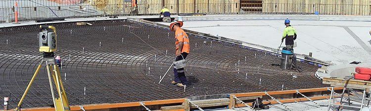 A group of construction workers are working on a construction site.