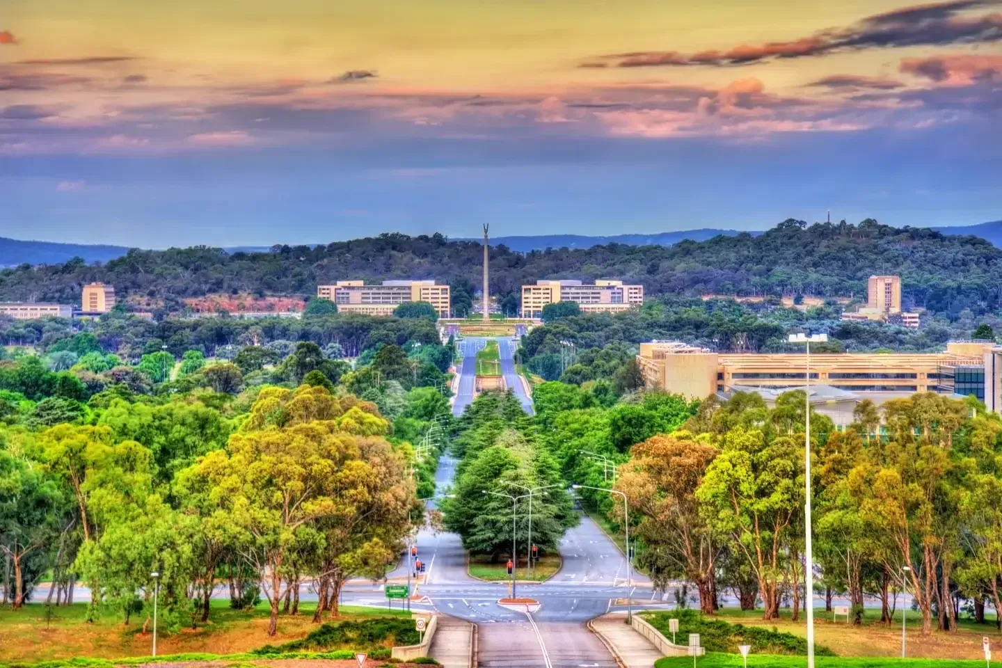 An aerial view of a city with trees and buildings in the background.