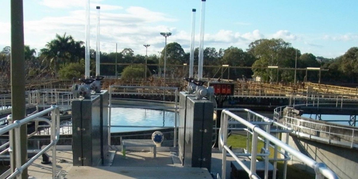 A large body of water is surrounded by a metal railing.