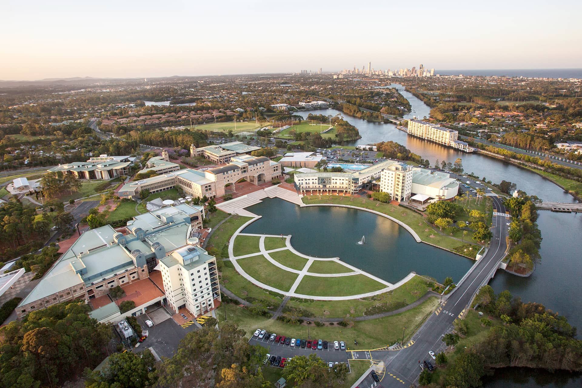 An aerial view of a lake surrounded by buildings and trees