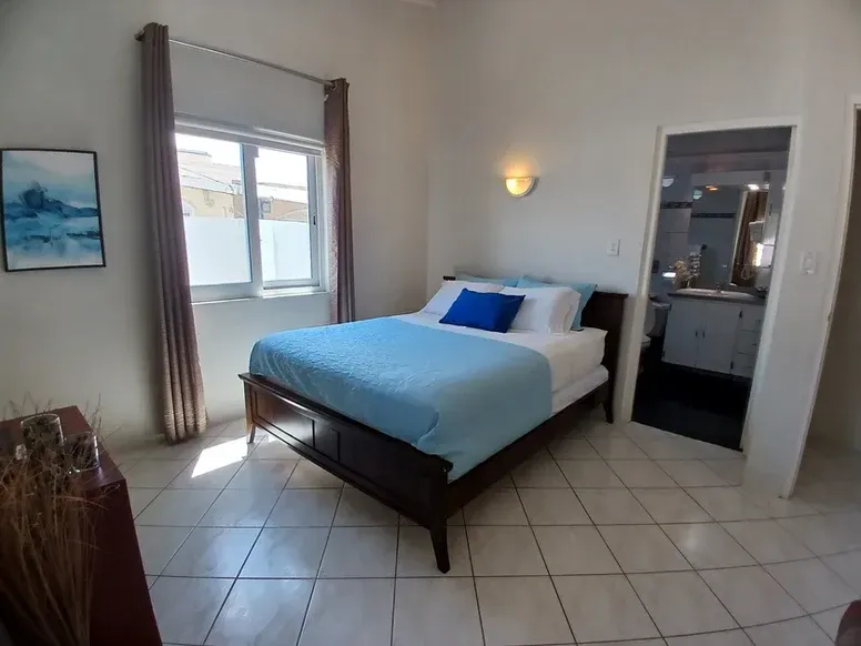 A bedroom with a bed and a picture on the wall