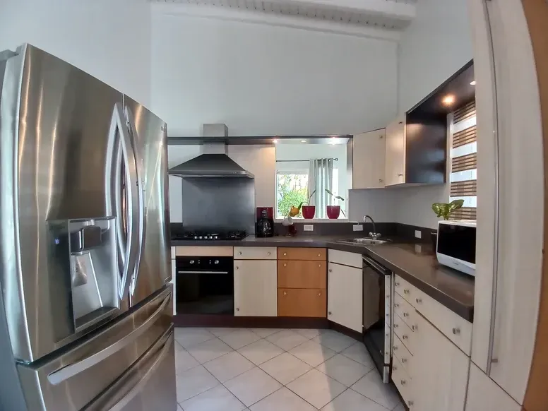 A kitchen with stainless steel appliances and white cabinets