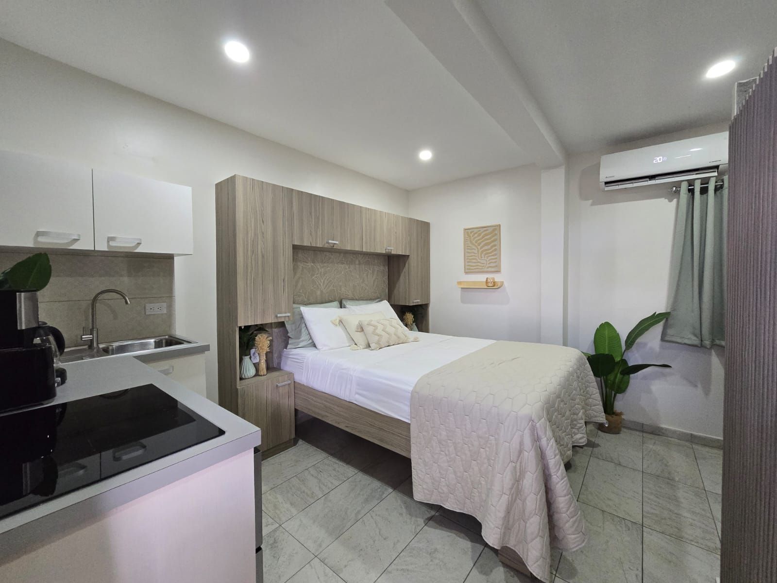 A hotel room with a bed , couch , table and chairs.