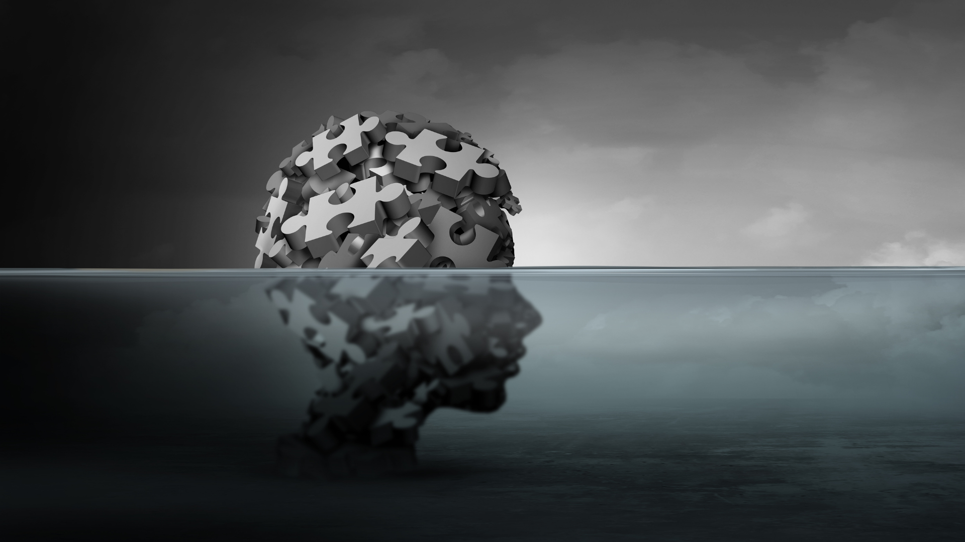 Head made of puzzle pieces above water, reflected with silhouette face in dark grayscale.